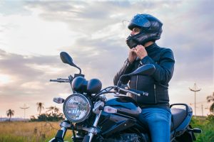 Man,Sitting,On,A,Motorcycle,,Wearing,Jeans,And,A,Black